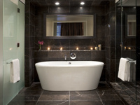 The suite's bathroom features rainforest shower and stand-alone bath
