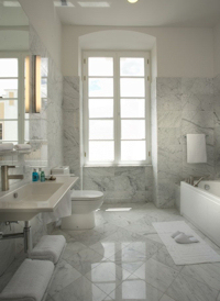 White tiles and natural light grace the bathroom
