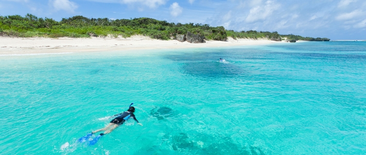 Snorkellers paddle towards one of Okinawa's ubiquitous beaches