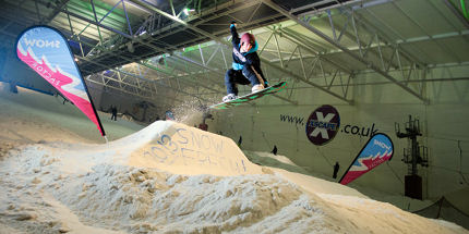 A slopestyle snowboarder gets some air