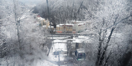 A gondola whisks skiers from the Olympic village of Roza Khutor